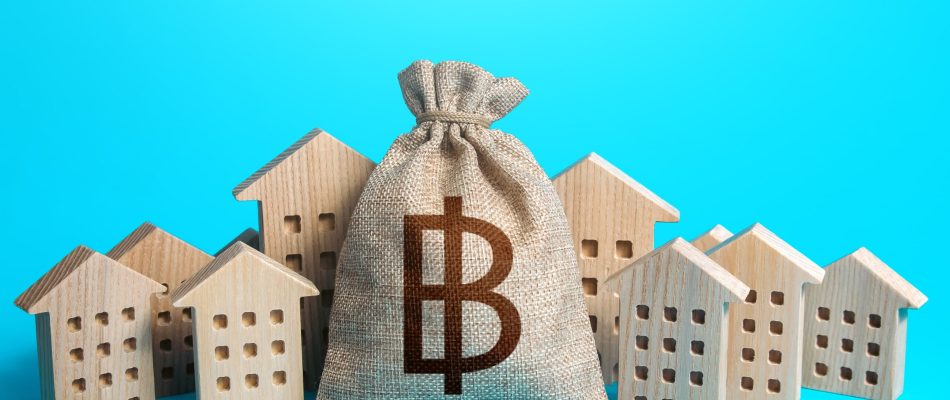 thai-baht-money-bag-among-town-houses-figurines-m-2023-11-27-05-11-24-utc-min-scaled